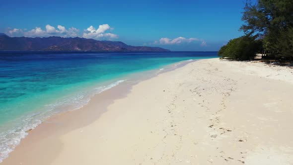 Aerial drone tourism of perfect island beach vacation by shallow ocean and white sand background of 