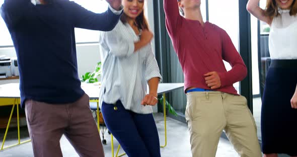Business executives dancing in office