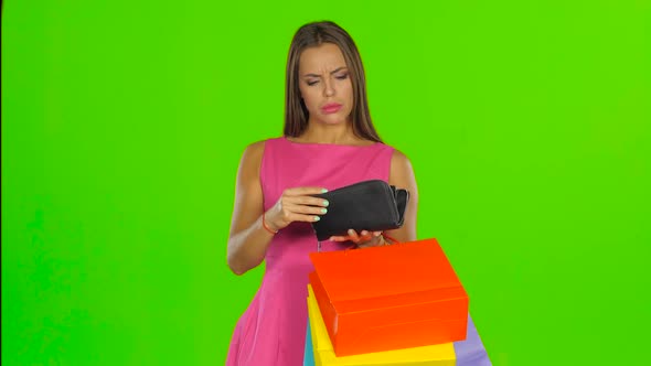 Woman Looking at Purse and Dissatisfied, Green Screen