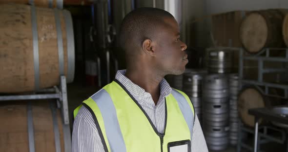 African American man smiling at camera and wearing high visibility vest