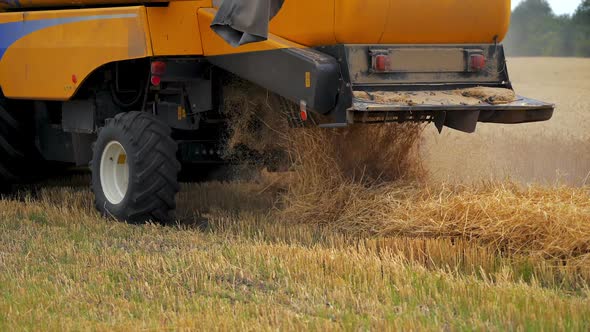 Selective focus on harvesting machinery detail. Heavy machinery is working the field.