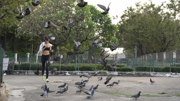 4K Hispanic woman jogging in city street at summer sunset.