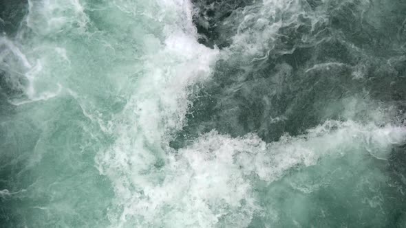 Turquoise and White Water Flowing Violently in a Powerful Mountain River. View From Top