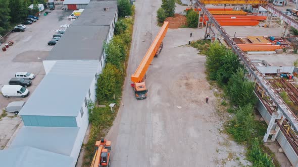 Transporting Orange Parts of Cranes on the Truck Outdoors