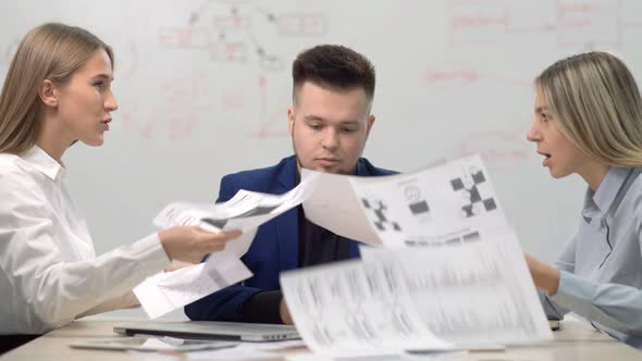 Two Angry Businesswoman Having Dispute at Business Team Meeting Showing Financial Paper Documents