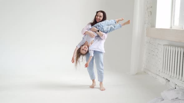 Beautiful Happy Family at Photo Shoot in White Photo Studio