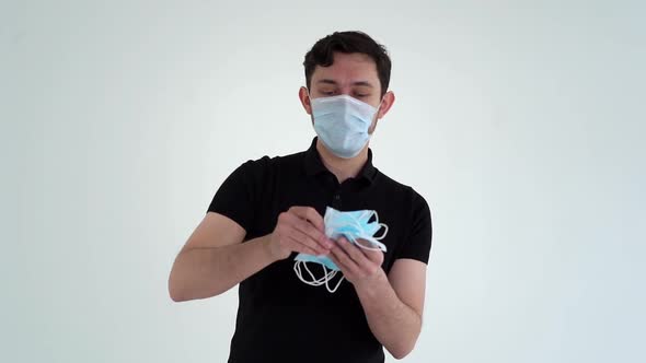 Portrait of Young Man Wearing Protective Mask Throwing Medical Masks.