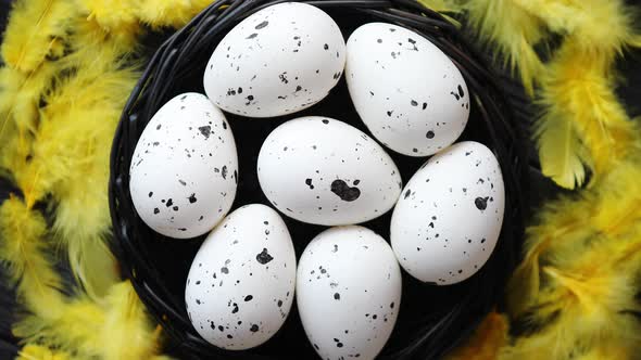 Whole Chicken Eggs in a Nest on a Black Rustic Wooden Background