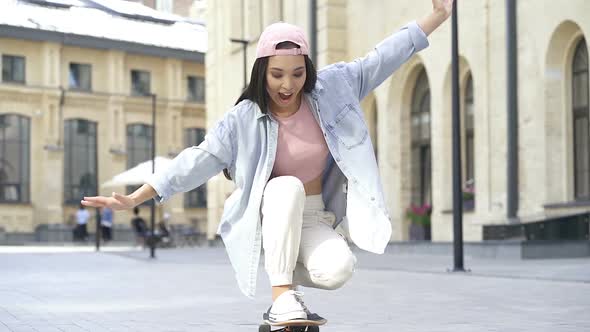 Woman having fun and balancing on the skateboard. 