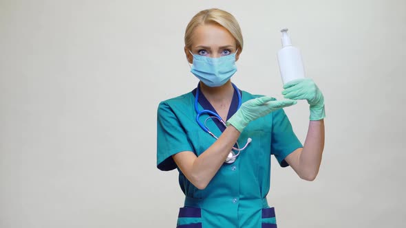 Medical Doctor Nurse Wearing Protective Mask - Holding Sanitizing Spray or Gel or Liquid Soap