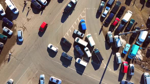 Aerial drone view of cars moving fast on a busy road.