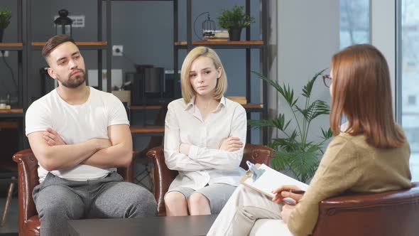 Young Caucasian Couple Offended By Each Other Sit at Consultation with Family Psychologist