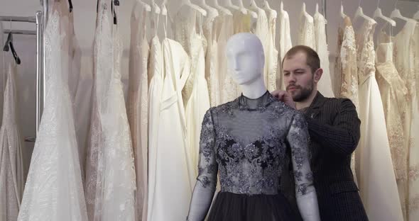 The Tailor Fastening an Evening Dress on a Mannequin in Studio