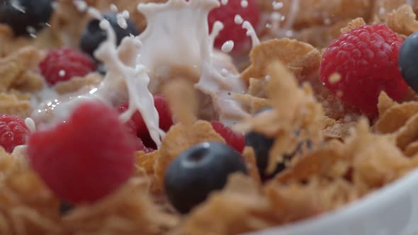 Closeup of raspberries splashing into bowl of cereal in slow motion; shot on Phantom Flex 4K at 1000 alt