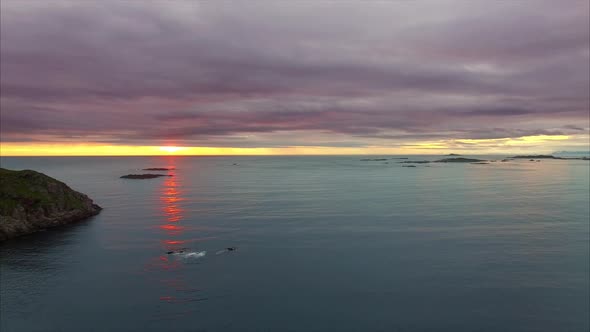 Midnight sun over the ocean in Norway, aerial footage.