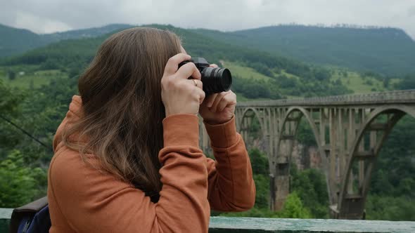 Closeup Young Woman Taking Pictures of Djurdjevic bridge.