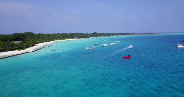 Wide angle flying abstract view of a white sandy paradise beach and blue ocean background