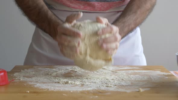 Man's hand preparing pizza dough