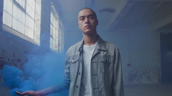 Fashionable young man in an abandoned warehouse