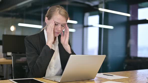 Tired Young Businesswoman Having Headache in Office