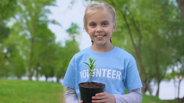 Cheerful Female Kid Holding Plant Smiling Camera, Natural Resources Conservation