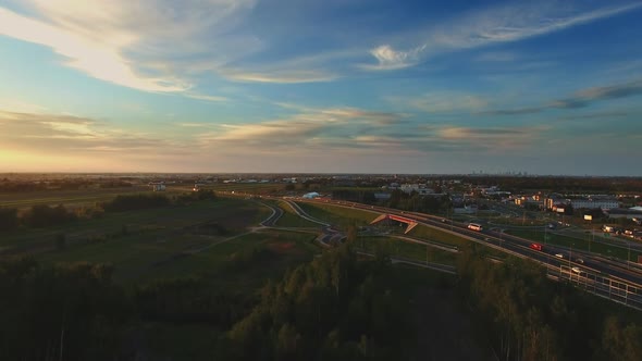 Complex Road Junction. Sunny Day, Sunset. Modern Europe. Aerial High Altitude Drone Flight.