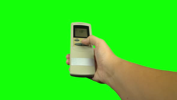 Hand Using Air Conditioner Controller To Change the Temperature. Green Screen