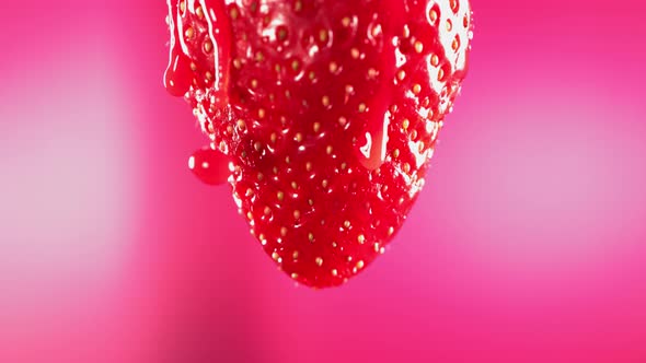 Slow Motion Macro Shot of Flowing Juice From Strawberry