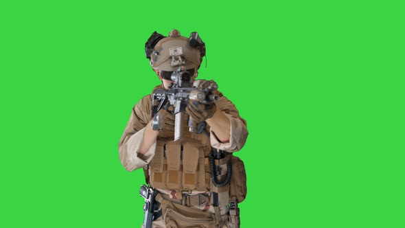 Soldier Shoots Aming and Shooting with Rifle on a Green Screen, Chroma Key