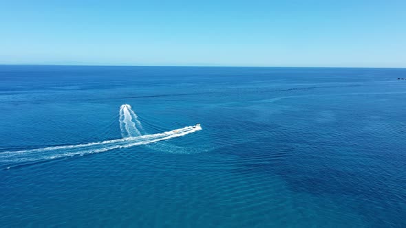 Aerial View of a Motor Boat Towing a Tube, Zakynthos, Greece