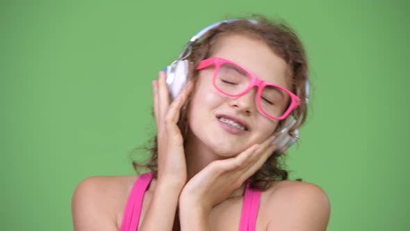 Young Beautiful Nerd Woman Listening To Music