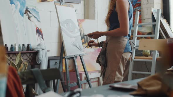 Female Artist Painting Picture in Studio