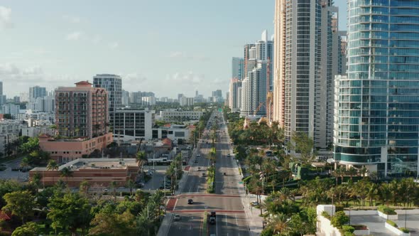 Epic Straight Drone Shot of Collins Avenue with the Oceanfront Modern Buildings