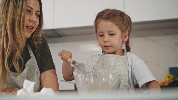 Low Angle Shot Mother and Daughter in Kitchen