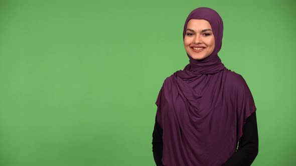 A Young Beautiful Muslim Woman Smiles at the Camera  Green Screen Background