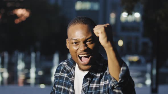 Male Portrait in City Happy Satisfied African American Guy Man Looking at Camera Rejoices Victory