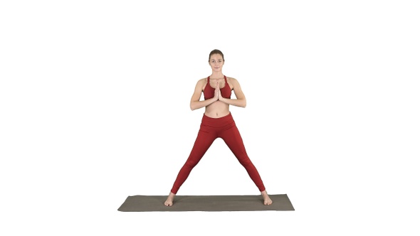 Young woman practicing yoga finishes doing Utthita parsvakonasana