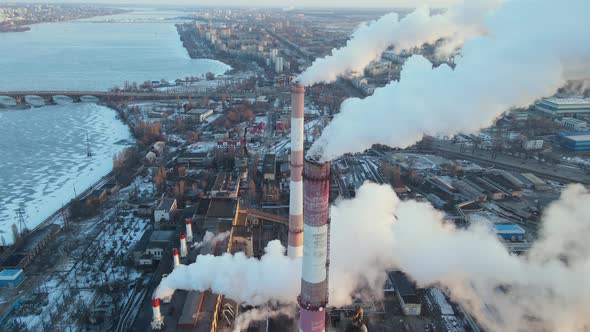 Emission smoke to atmosphere from industrial pipes at sunrise