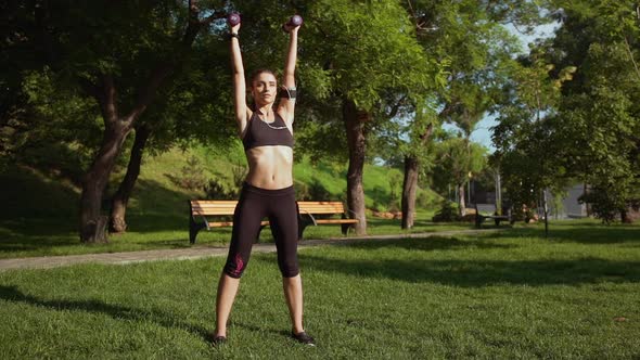 Young Beautiful Sportive Girl Training in Park