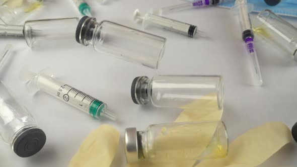 Syringes and falling ampoules. Slow motion.