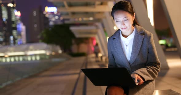 Business woman use of laptop computer at night