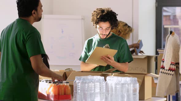 Group of Volunteers Packing Food in Donation Boxes