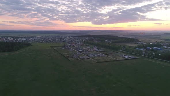 Aerial view of territory of the cottage village at sunset 18