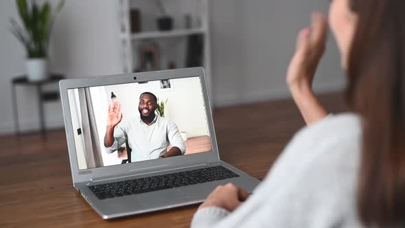 A Young Woman Is Using a Laptop for Video Call