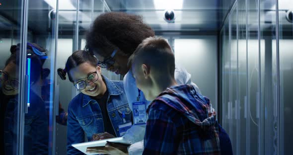 Female Technician Showing Around Children in a Server Park