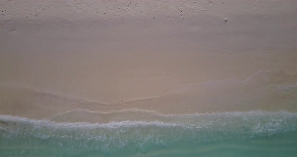 Natural birds eye tourism shot of a white sand paradise beach and blue ocean background in high reso