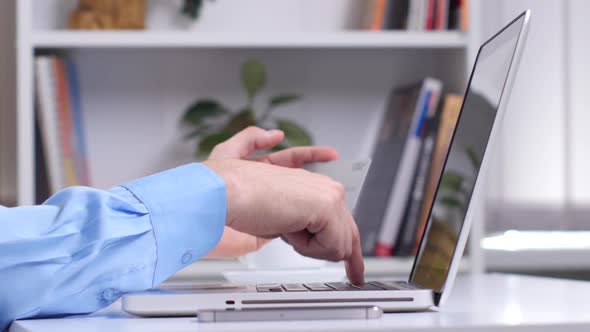 Man Shopping Online By Smartphone and Payment By Credit Card and Drinks Coffee. Close Up