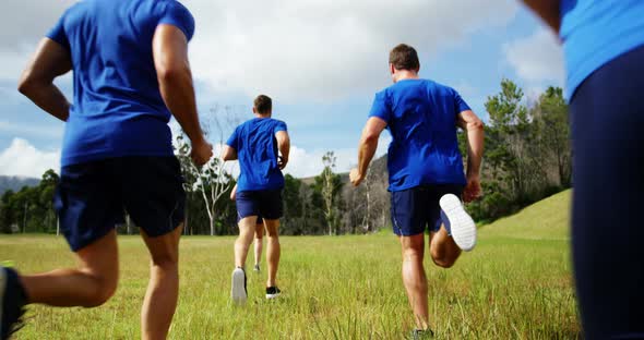 Fit people jogging in boot camp 