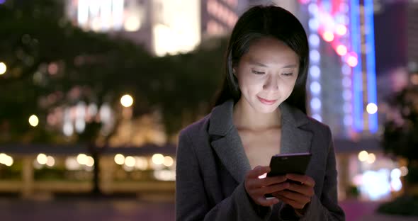 Business Woman Use of Mobile Phone in City at Night