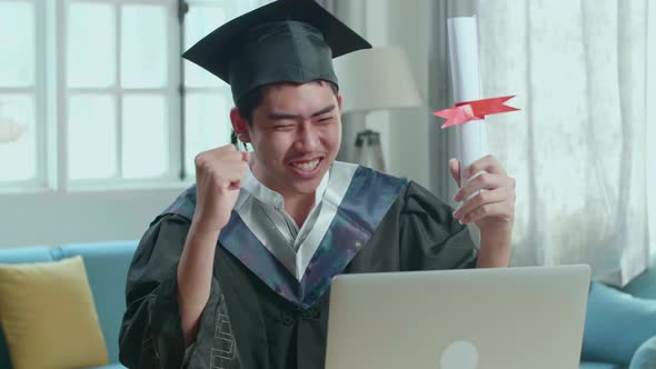 Asian Man Celebrating With University Certificate During An Online Video Call At Home